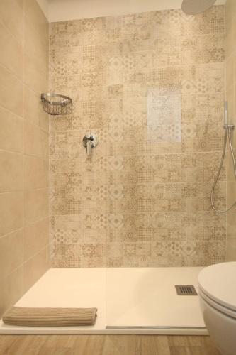 a bathroom with a shower with a toilet at Romantic beach house with jacuzzi in San Mauro a Mare