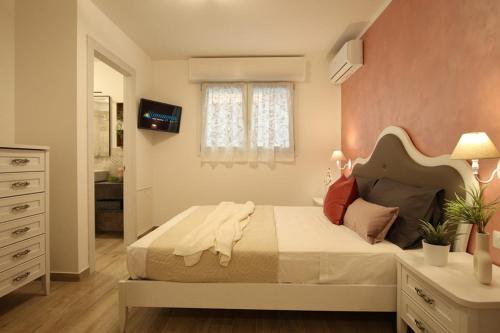 a bedroom with a large bed and a window at Romantic beach house with jacuzzi in San Mauro a Mare