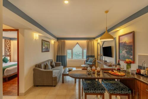 a living room with a couch and a table in a room at Sterling Ooty Elk Hill in Ooty