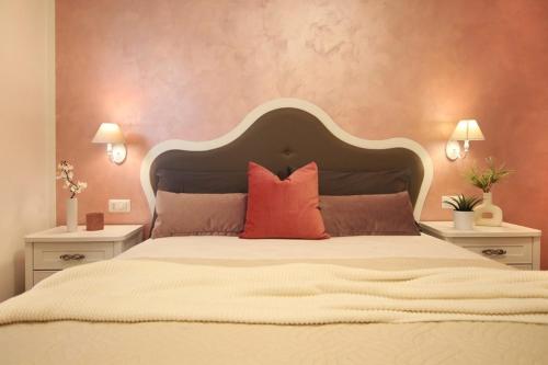 a bedroom with a large bed with two night stands at Romantic beach house with jacuzzi in San Mauro a Mare