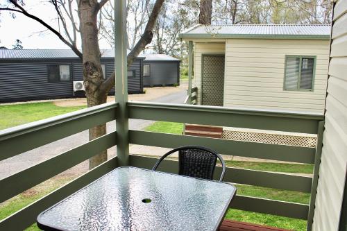a table on the balcony of a house at BIG4 Rutherglen Holiday Park in Rutherglen