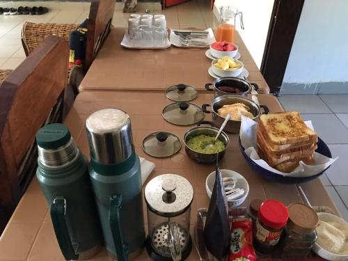 a table with some food on top at Home stay studio 62 Guesthouse in Jinja