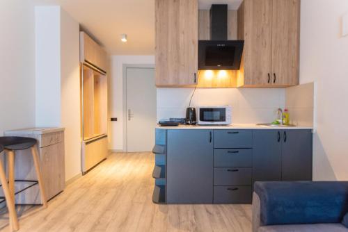 a kitchen with a microwave and a counter top at Go-Gudauri The Atrium Residence in Gudauri