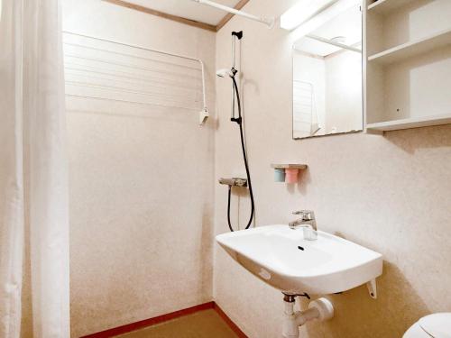 a bathroom with a sink and a shower and a mirror at 4 person holiday home in HENÅN in Nösund
