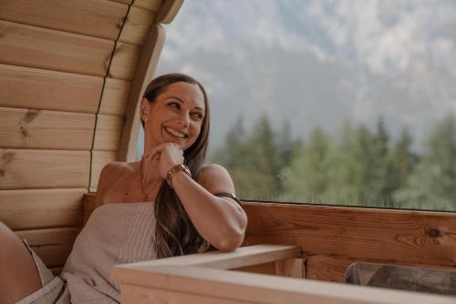 a woman sitting in a train car looking out the window at Mountain Residence Riesgut - Sound of Music in Werfen