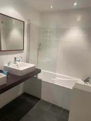 a white bathroom with a sink and a shower at Maison confortable à La Garde-Freinet, 160 m², vue ville in La Garde-Freinet
