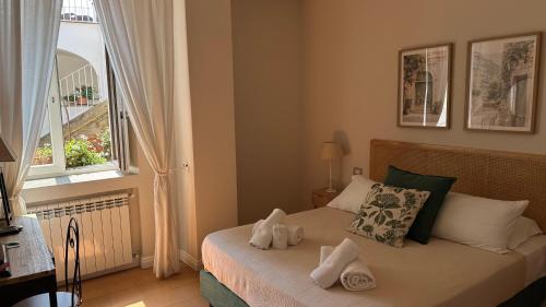 a bedroom with a bed with towels on it at Palazzo Gargano in Prignano Cilento
