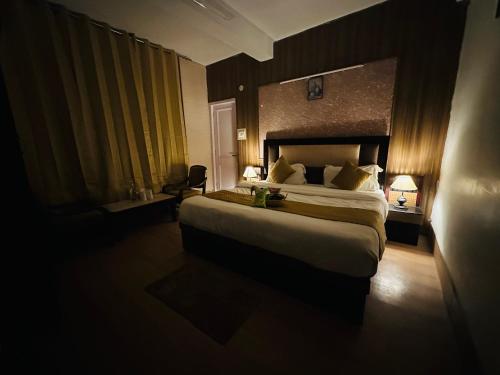 a bedroom with a large bed in a hotel room at Hotel Nature Valley in Manāli