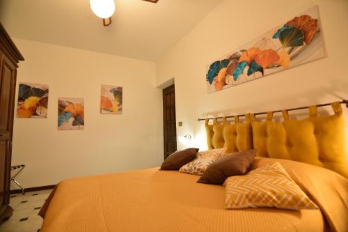 a bedroom with a bed with an orange bedspread at Da Nonna Nucci in Ovada