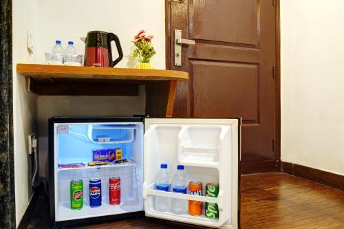 a small refrigerator with its door open in a room at Hotel Cabana 5 Mins Walking Distance From NDLS Station in New Delhi