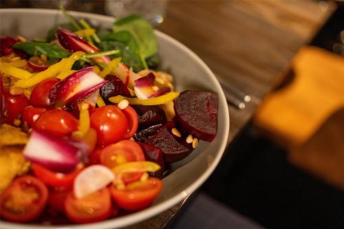 a salad in a white bowl on a table at Radisson Blu Hotel, Hamburg in Hamburg