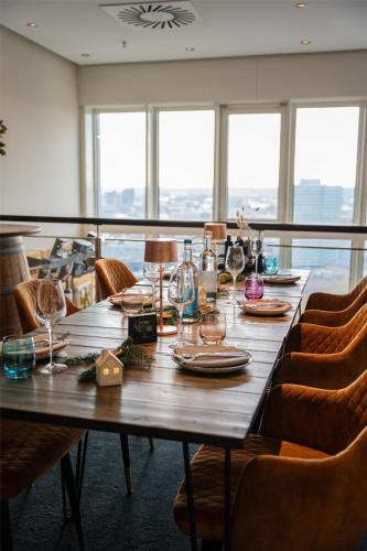 a wooden table with plates and glasses on it at Radisson Blu Hotel, Hamburg in Hamburg