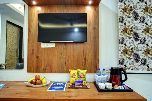 a table with food and a television on a wall at Hotel Cabana 5 Mins Walking Distance From NDLS Station in New Delhi