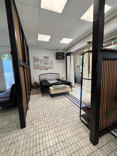 a living room with a bed and a table at Villa Arche 1 in Neuenkirchen-Vörden