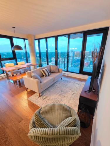 a living room with a couch and a television in a building at Dream Apartment in Longueuil