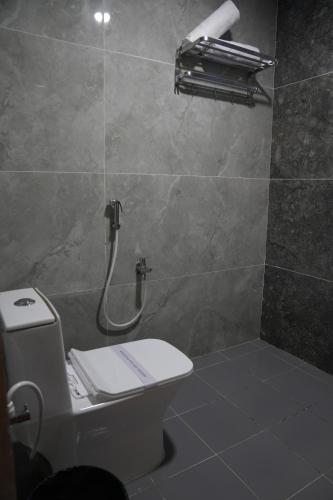 a bathroom with a toilet and a shower stall at Hotel Vamshi Elite in Kondapur