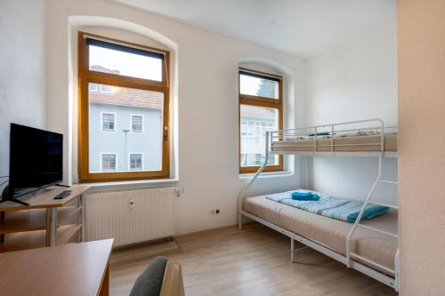 En eller flere senge i et værelse på Wohnen in 09599 Freiberg