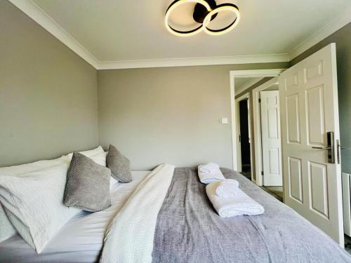 a bedroom with a bed with two towels on it at Poppies in Colchester