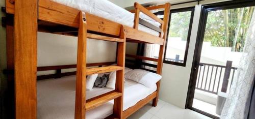 a couple of bunk beds in a room with a window at LG318 New Brenthill Premium Condo near SMBaguio in Baguio