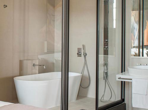 a bathroom with a bath tub and a sink at Villa Agrippina Gran Meliá – The Leading Hotels of the World in Rome