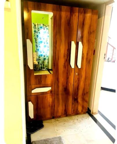 a room with a wooden door with a mirror at Vista villa Where luxury meets comfort MTDC Affiliated in Deolāli