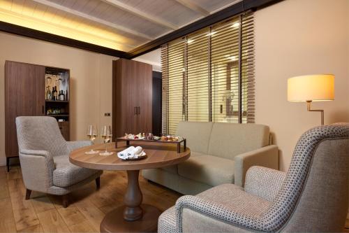 a living room with a table and chairs at Villa Agrippina Gran Meliá – The Leading Hotels of the World in Rome