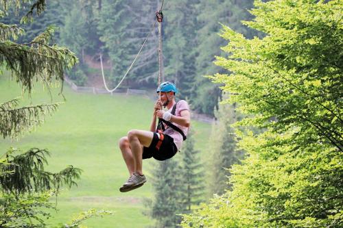 a man in the air on a zip line at U dobrého pastiera in Ružomberok