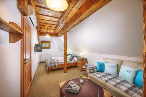a living room with a couch and a bed at U dobrého pastiera in Ružomberok
