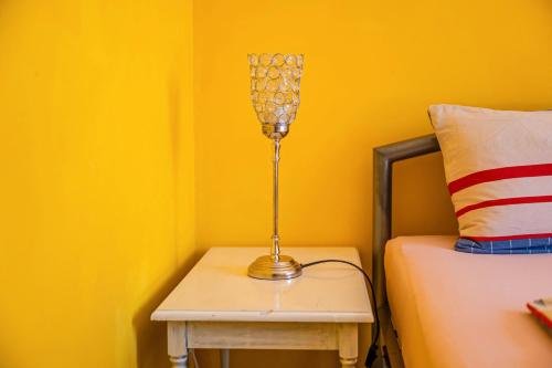 a lamp on a side table next to a bed at Gästehaus Ziegler in Neuenkirchen