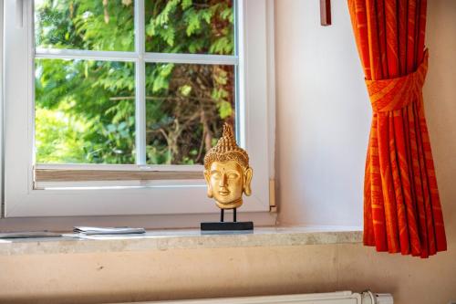 a gold mask sitting on a window sill at Gästehaus Ziegler in Neuenkirchen