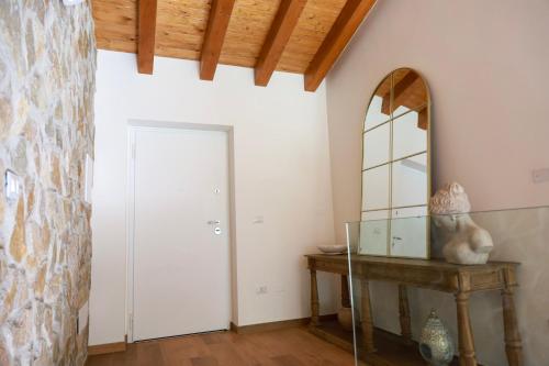 a room with a door and a mirror and a table at Le Radici in Sanza