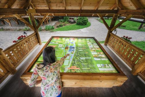 a woman looking at a map on a glass table at U dobrého pastiera in Ružomberok