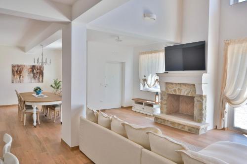 a living room with a couch and a fireplace at Le Radici in Sanza