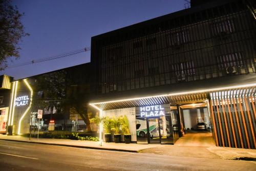 a store with lights on the side of a street at Hotel Plaza Cascavel in Cascavel
