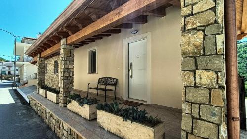 a house with a porch with a chair on it at Le Radici in Sanza