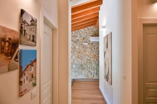 a hallway leading to a room with a stone wall at Le Radici in Sanza