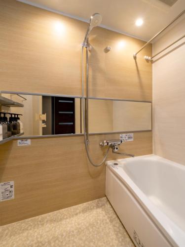 a bathroom with a bath tub and a shower at TOKYO STAY in Kamata in Tokyo