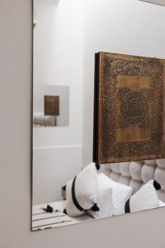 a mirror on a table with a picture on it at Riad Kasbah privilège and SPA in Marrakech