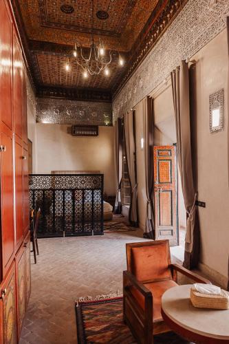 a living room with a couch and a table at Riad Kasbah privilège and SPA in Marrakech