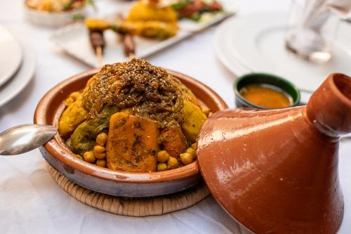 a bowl of food sitting on top of a table at Riad Kasbah privilège and SPA in Marrakech