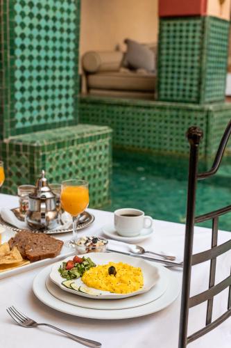 a table with a plate of food on top of it at Riad Kasbah privilège and SPA in Marrakech