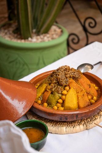 a bowl of food sitting on top of a table at Riad Kasbah privilège and SPA in Marrakech
