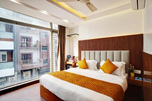 a bedroom with a large bed and a large window at Hotel Cabana 5 Mins Walking Distance From NDLS Station in New Delhi