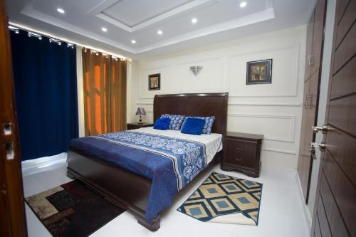 a bedroom with a bed with a blue comforter at Heaven Stay in Murree