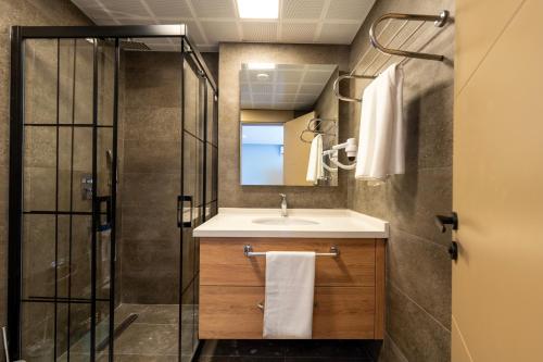 a bathroom with a sink and a shower at Bun'ca Rooms in Antalya