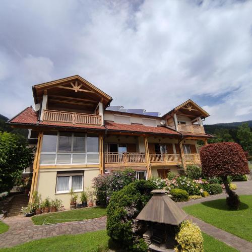 a large wooden house with a balcony at Haus Maria Bodensdorf in Tratten