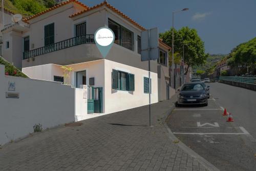 a car parked on a street next to a building at Luzia by the Sea - T1 Acolhedor a Passos da Praia in Calheta