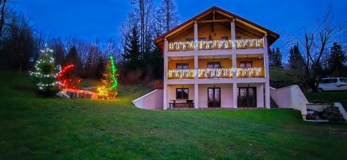 a house with christmas lights on the side of it at Nonićeva Hiža in Fužine