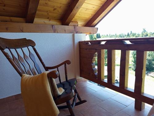 a room with two rocking chairs on a balcony at Nonićeva Hiža in Fužine