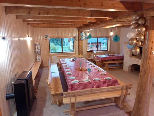 a dining room with a long table and a pool table at Nonićeva Hiža in Fužine
